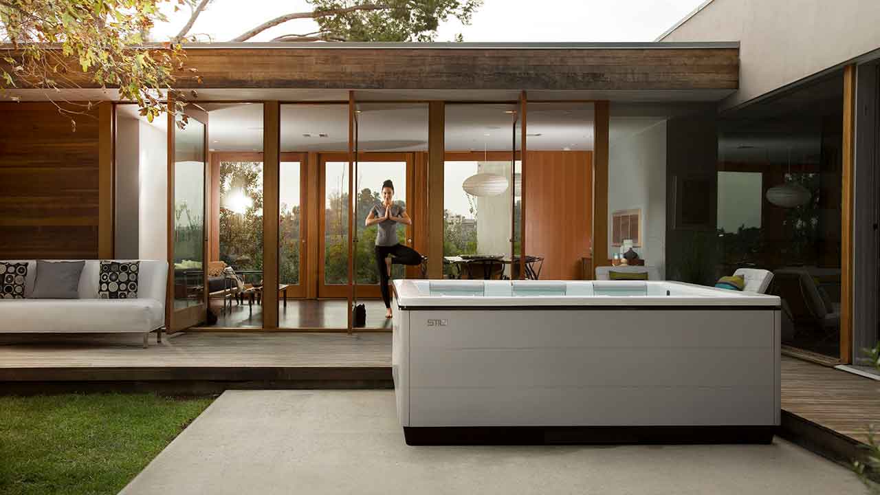 woman doing yoga by hot tub