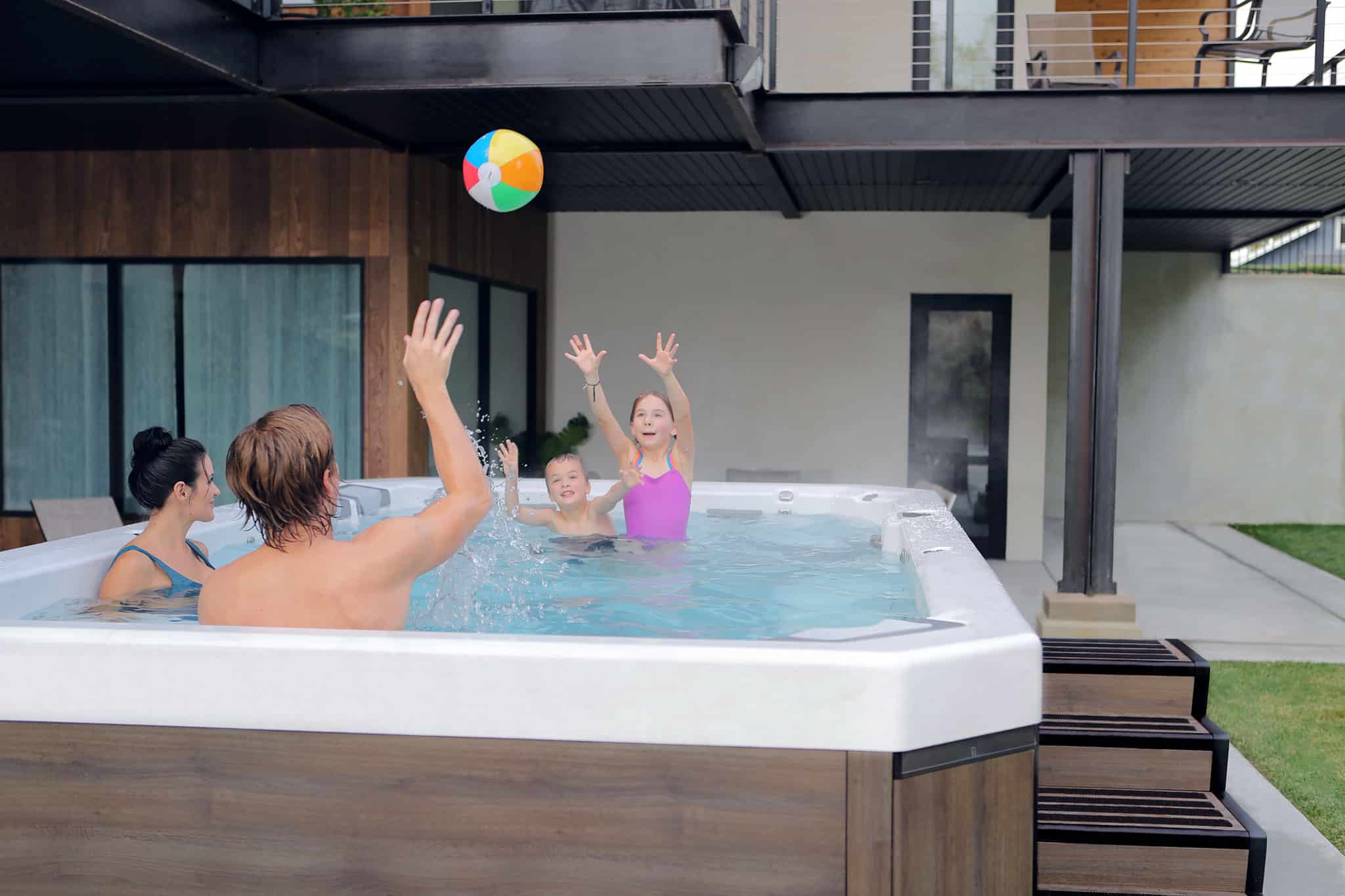 family playing in swim spa